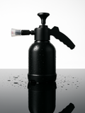 Black foam cannon on a reflective surface with water droplets
