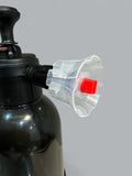 Black air compressor with a clear plastic nozzle and red button on a gray background