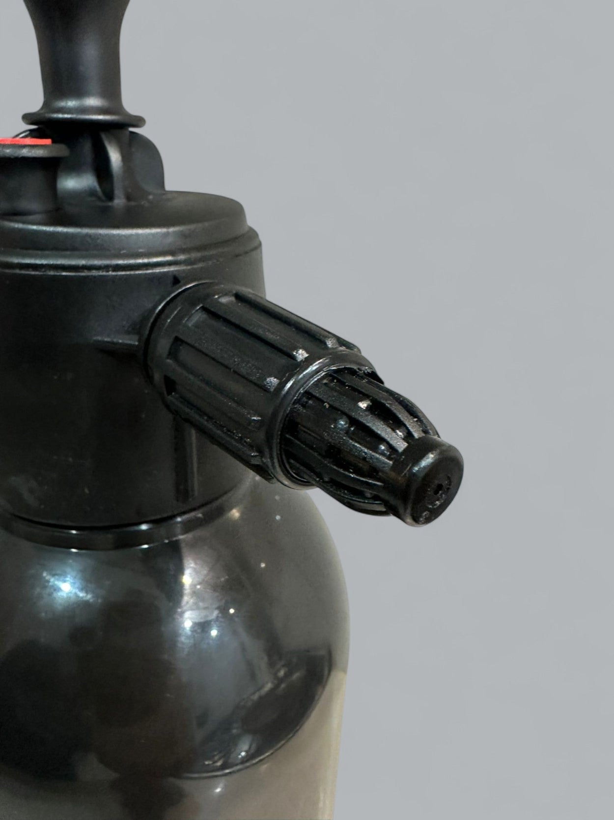 Black spray nozzle on a gray background